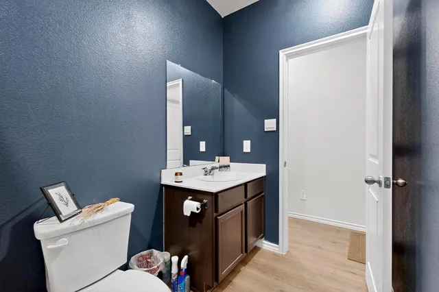 a bathroom with a sink a toilet and mirror
