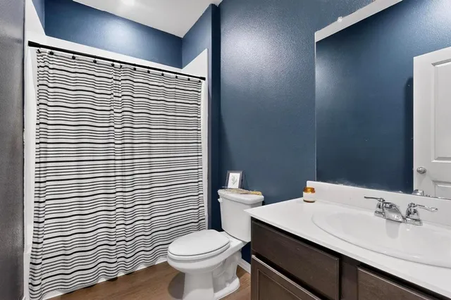 a bathroom with a sink a toilet and mirror