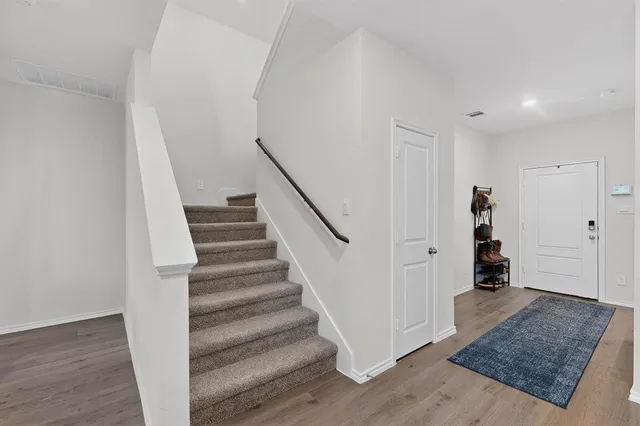 a view of entryway and hall with wooden floor