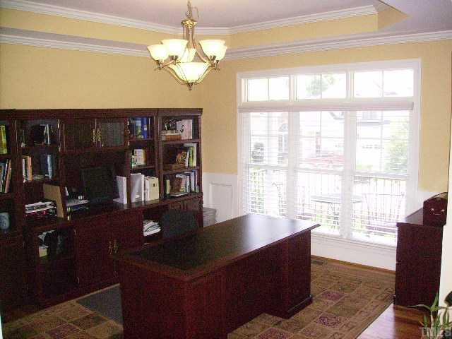 THIS LOVELY FORMAL DINING ROOM W/TRIPLE WINDOW WITH VIEW OF FRONT PORCH IS NOW BEING USED AS AN EXECUTIVE OFFICE OFFERING HARDWOOD FLOOR! Dining Room
