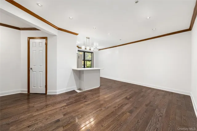 a view of a room with wooden floor and a window