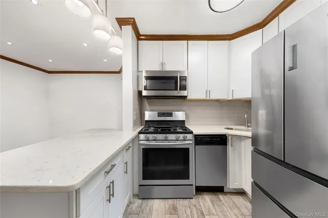 a kitchen with stainless steel appliances granite countertop a stove and a refrigerator
