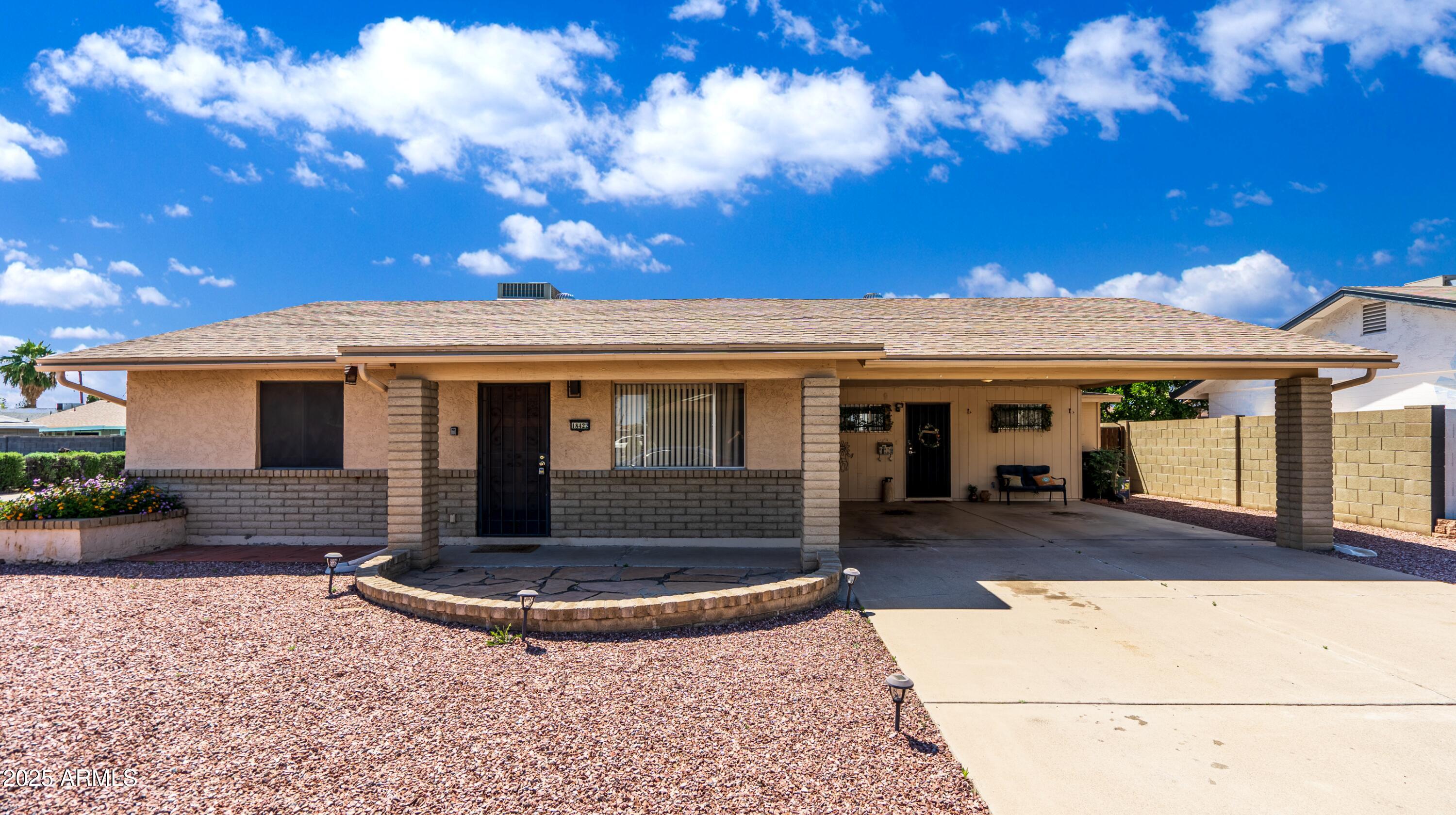 a view of a house with backyard porch and sitting area