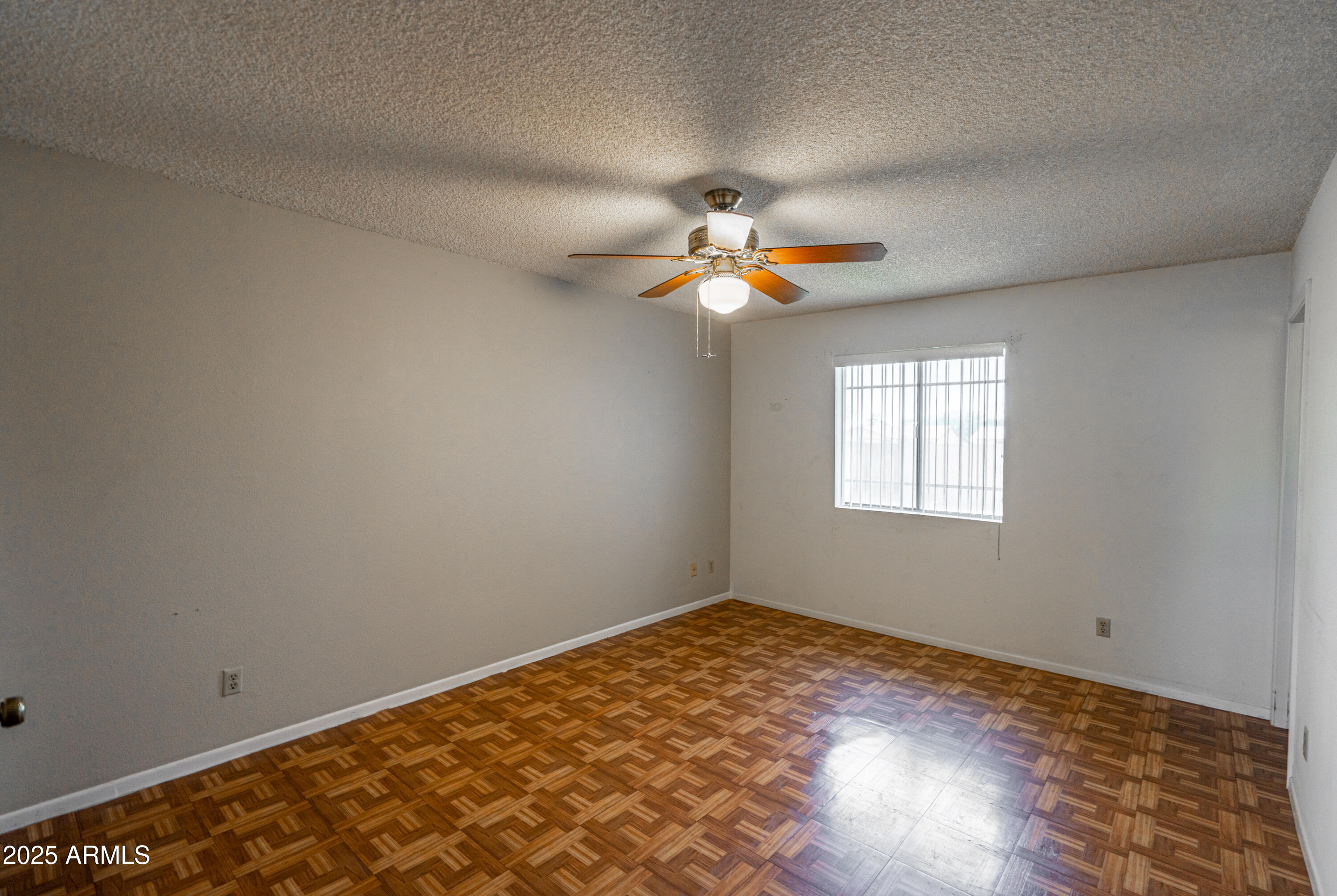 18422 North 30th Lane Phoenix, AZ 85053 - Photo 11 of 16 wooden floor in an empty room with a window