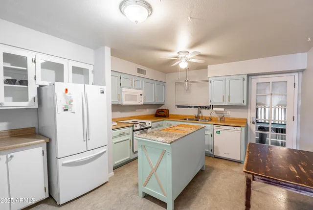 a kitchen with stainless steel appliances a stove a refrigerator and a cabinets