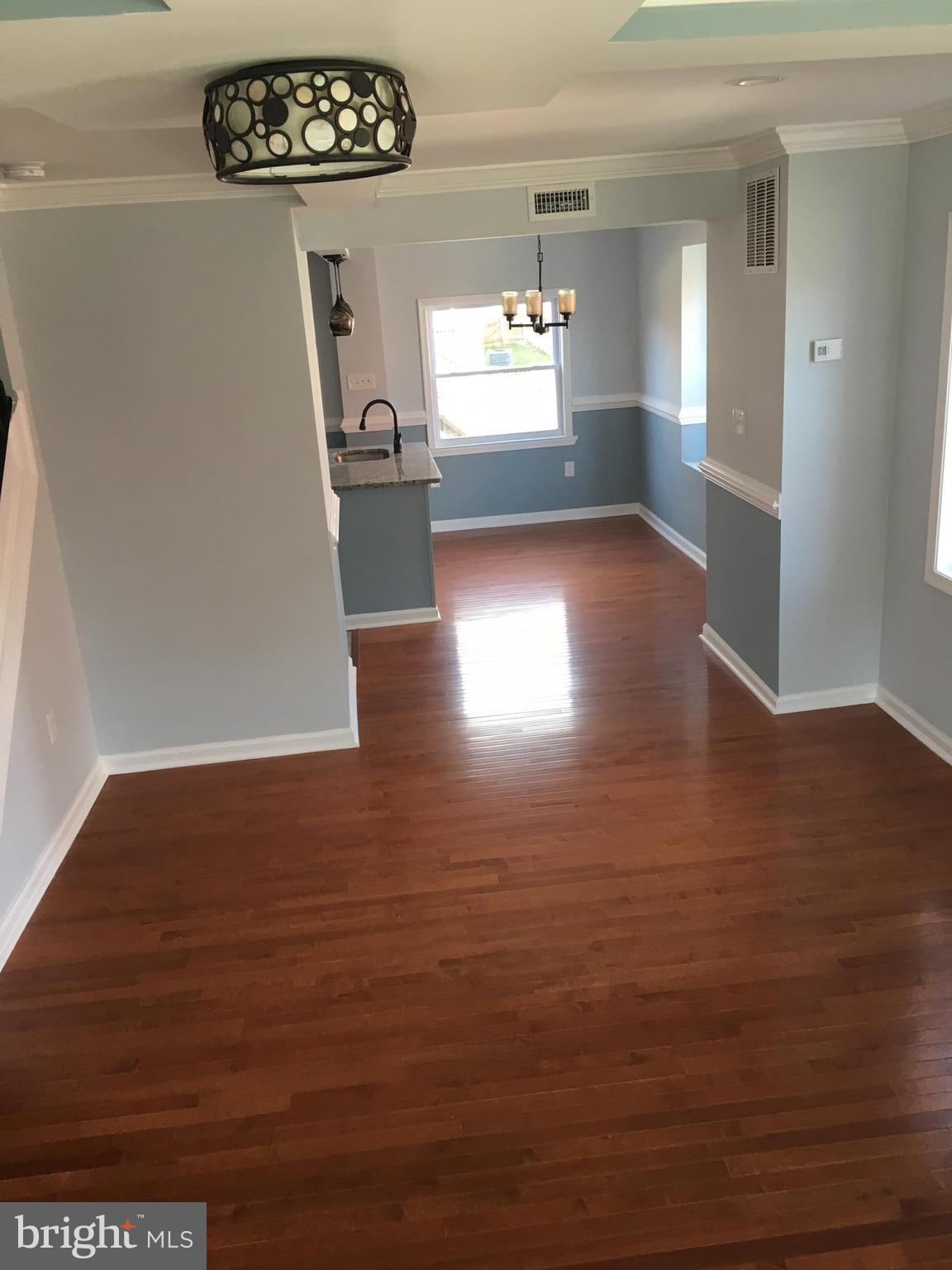 926 Arncliffe Road Baltimore, MD 21221 - Photo 3 of 24 a view of a hallway with wooden floor
