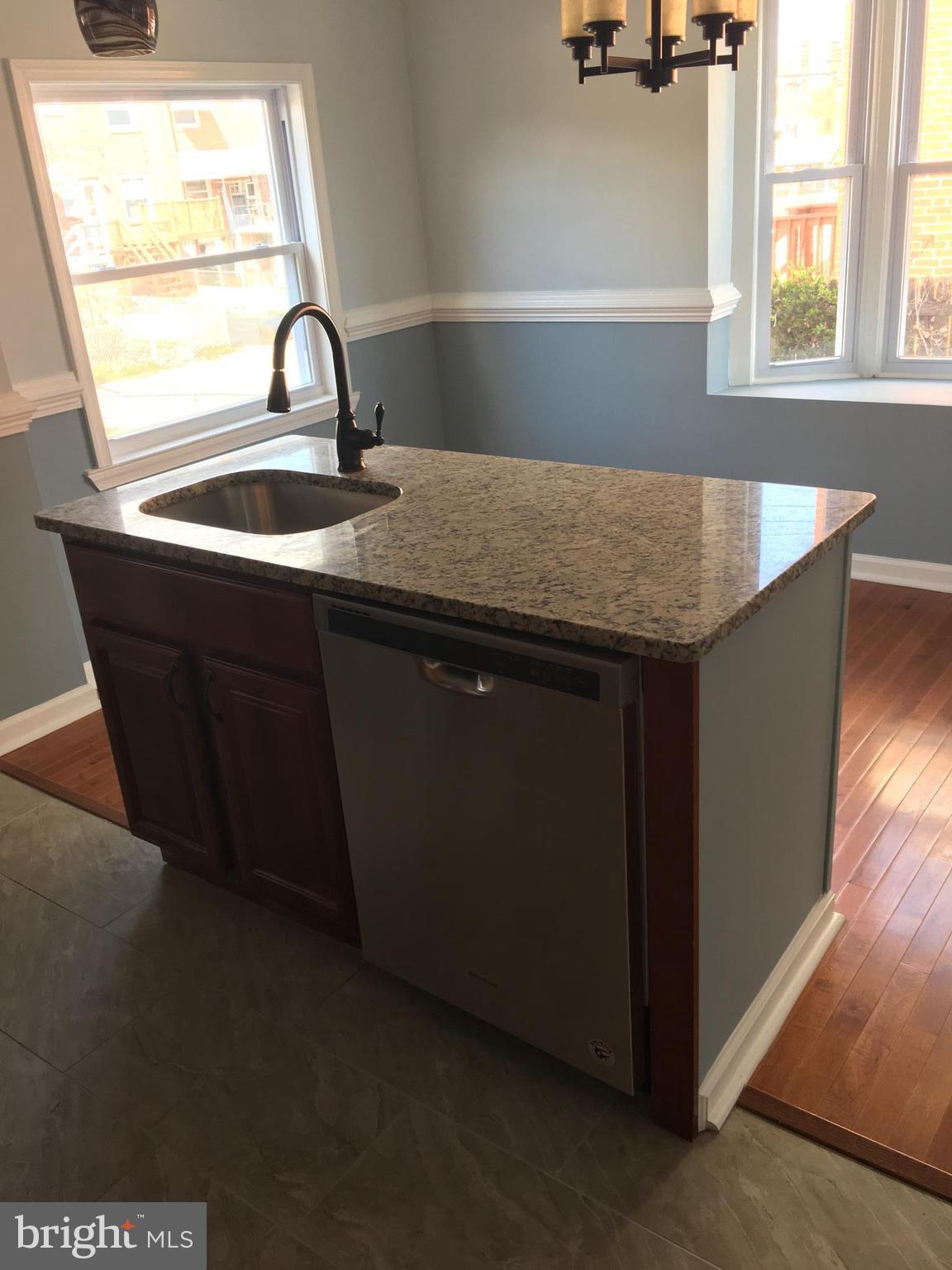 926 Arncliffe Road Baltimore, MD 21221 - Photo 24 of 24 a kitchen with a sink a window and potted plant
