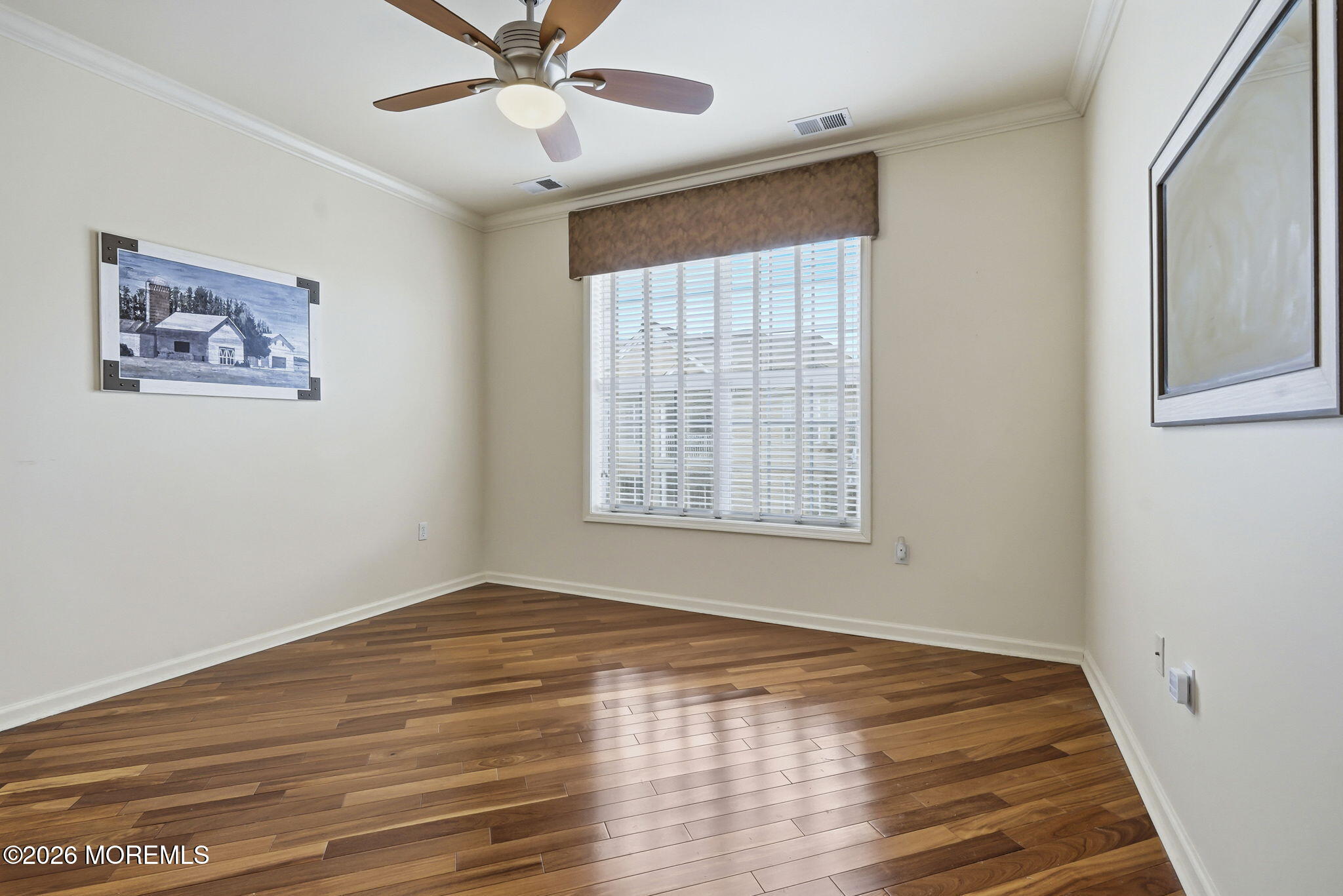 106 Potts Road Morganville, NJ 07751 - Photo 16 of 25 a view of an empty room with wooden floor and a window