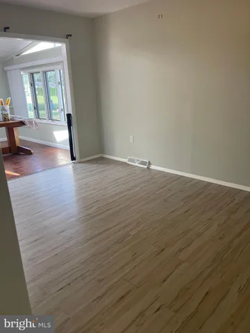 a kitchen with stainless steel appliances granite countertop a stove a sink and white cabinets