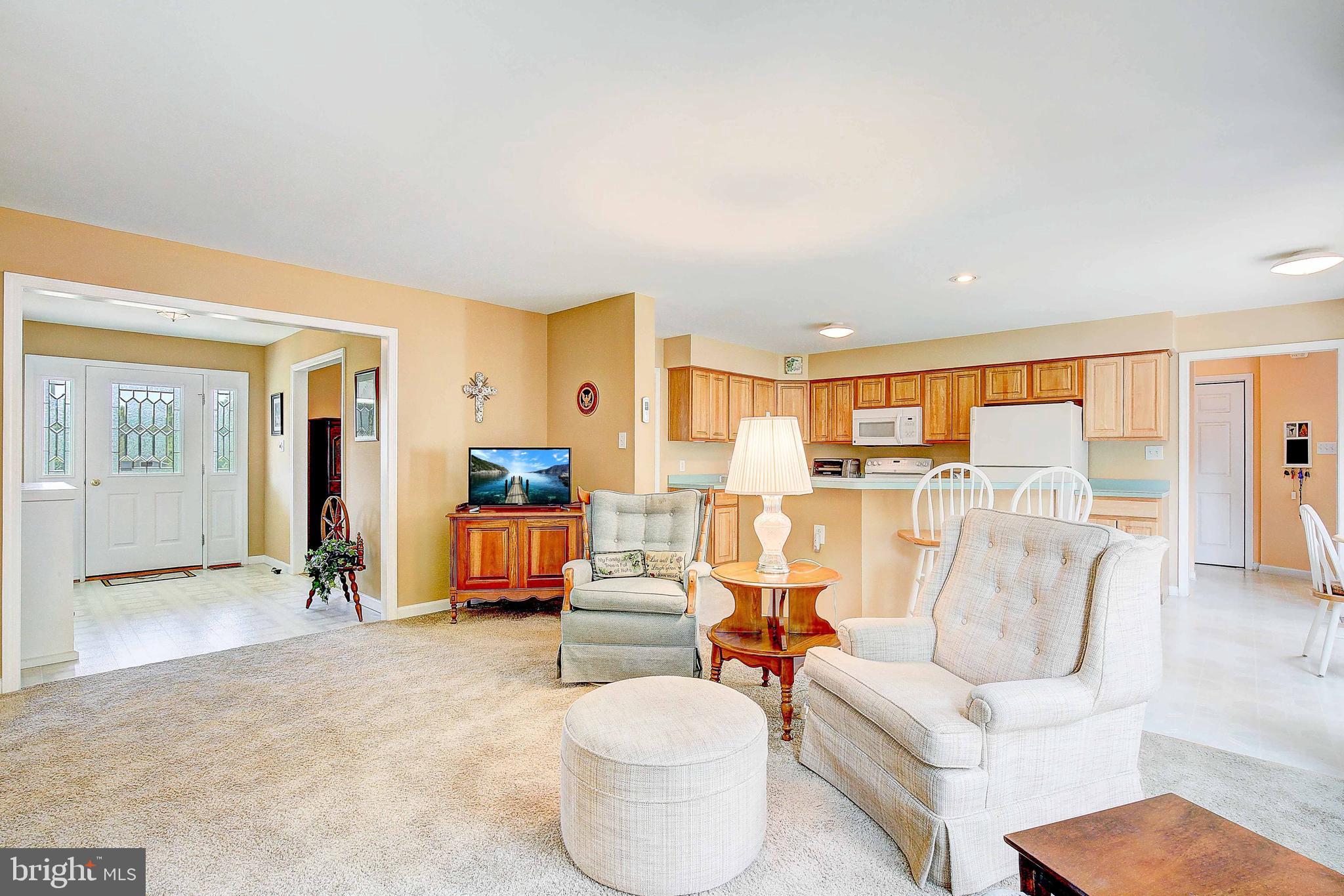 4650 Paul Hance Road Huntingtown, MD 20639 - Photo 26 of 57 a living room with furniture and a view of kitchen