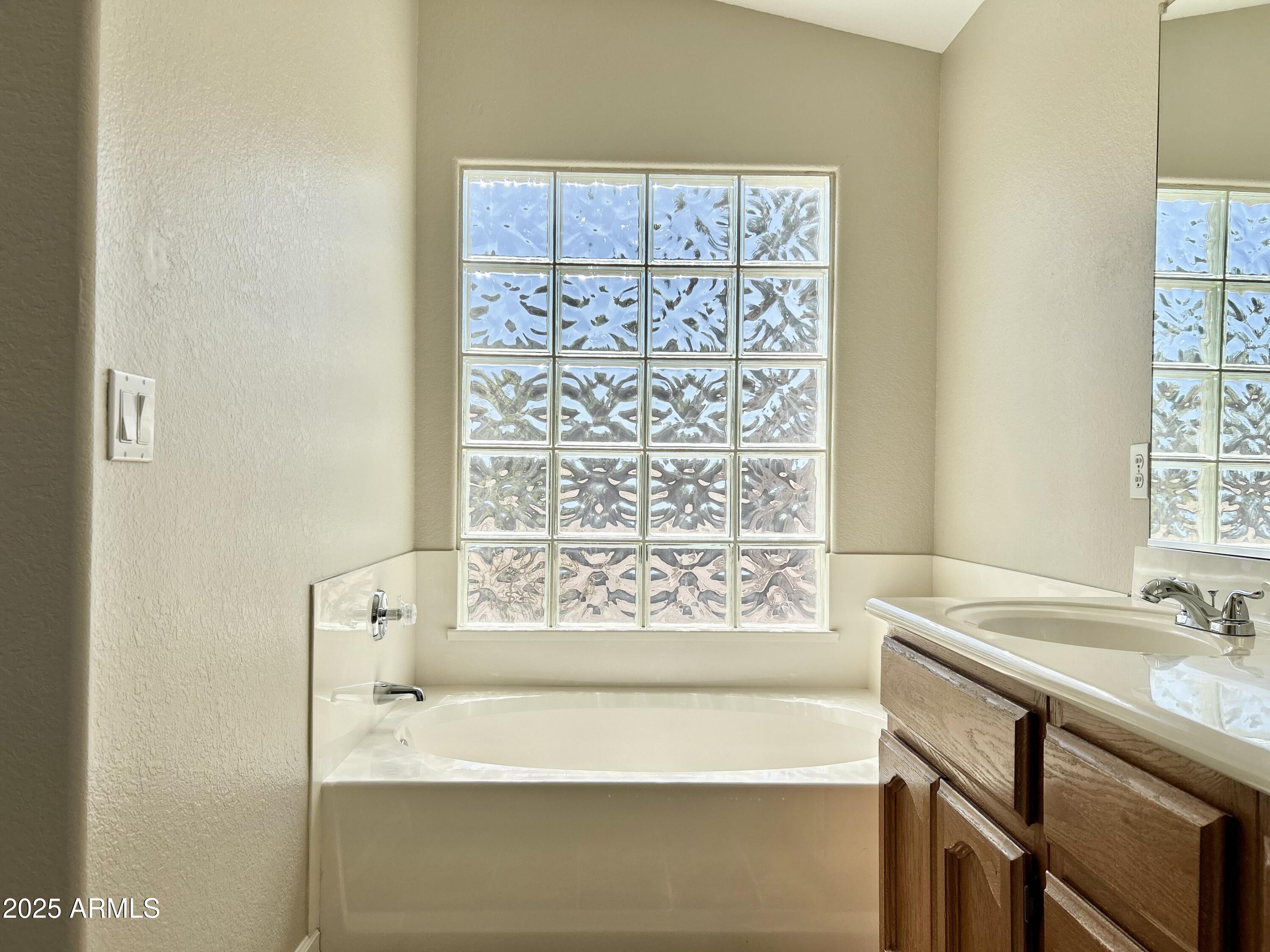 437 West San Angelo Gilbert, AZ 85233 - Photo 12 of 21 a bathroom with a bathtub and a sink