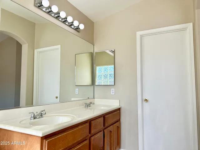 a bathroom with a sink vanity and a mirror
