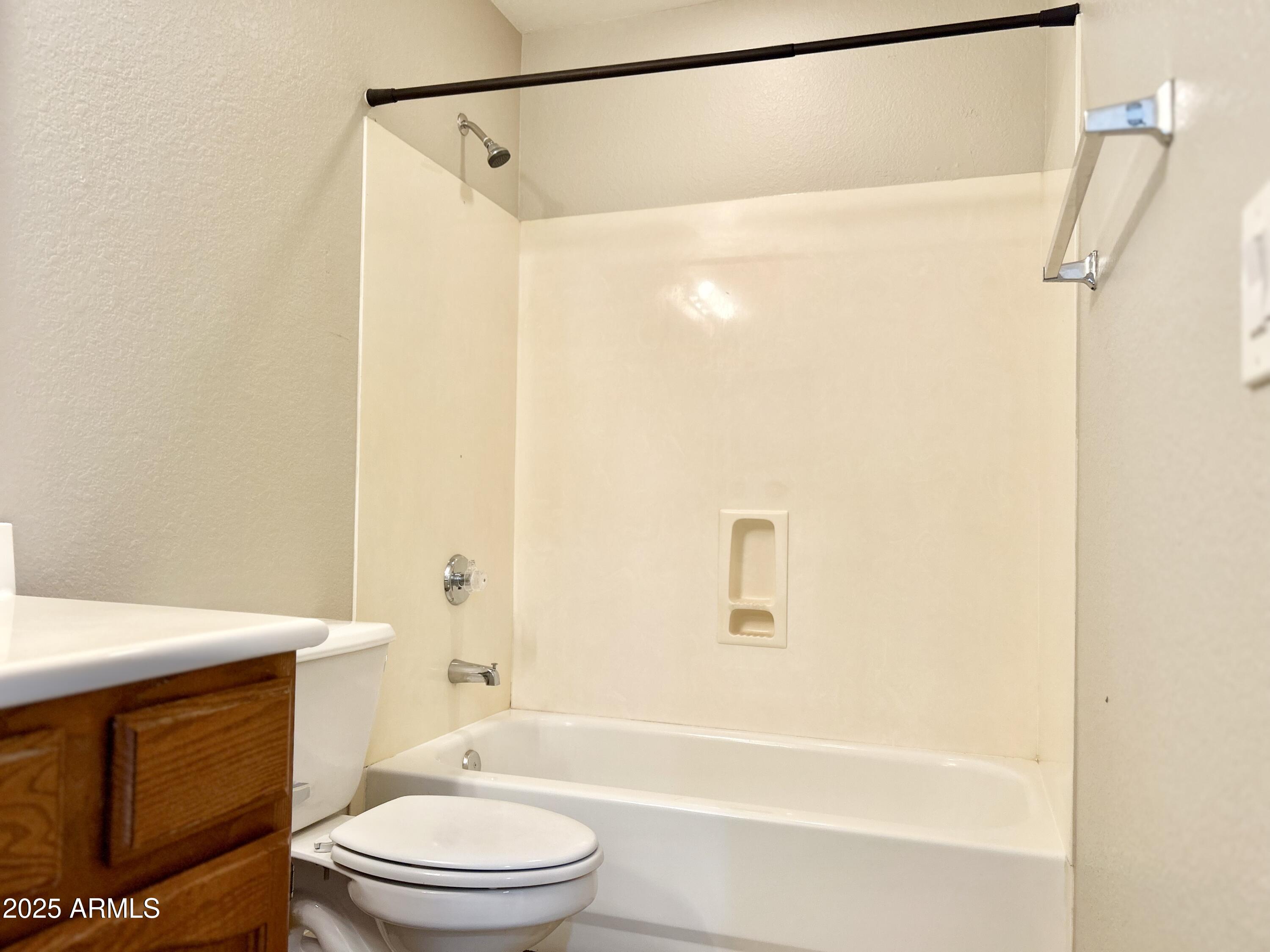 437 West San Angelo Gilbert, AZ 85233 - Photo 19 of 21 a bathroom with a toilet a sink and a bathtub