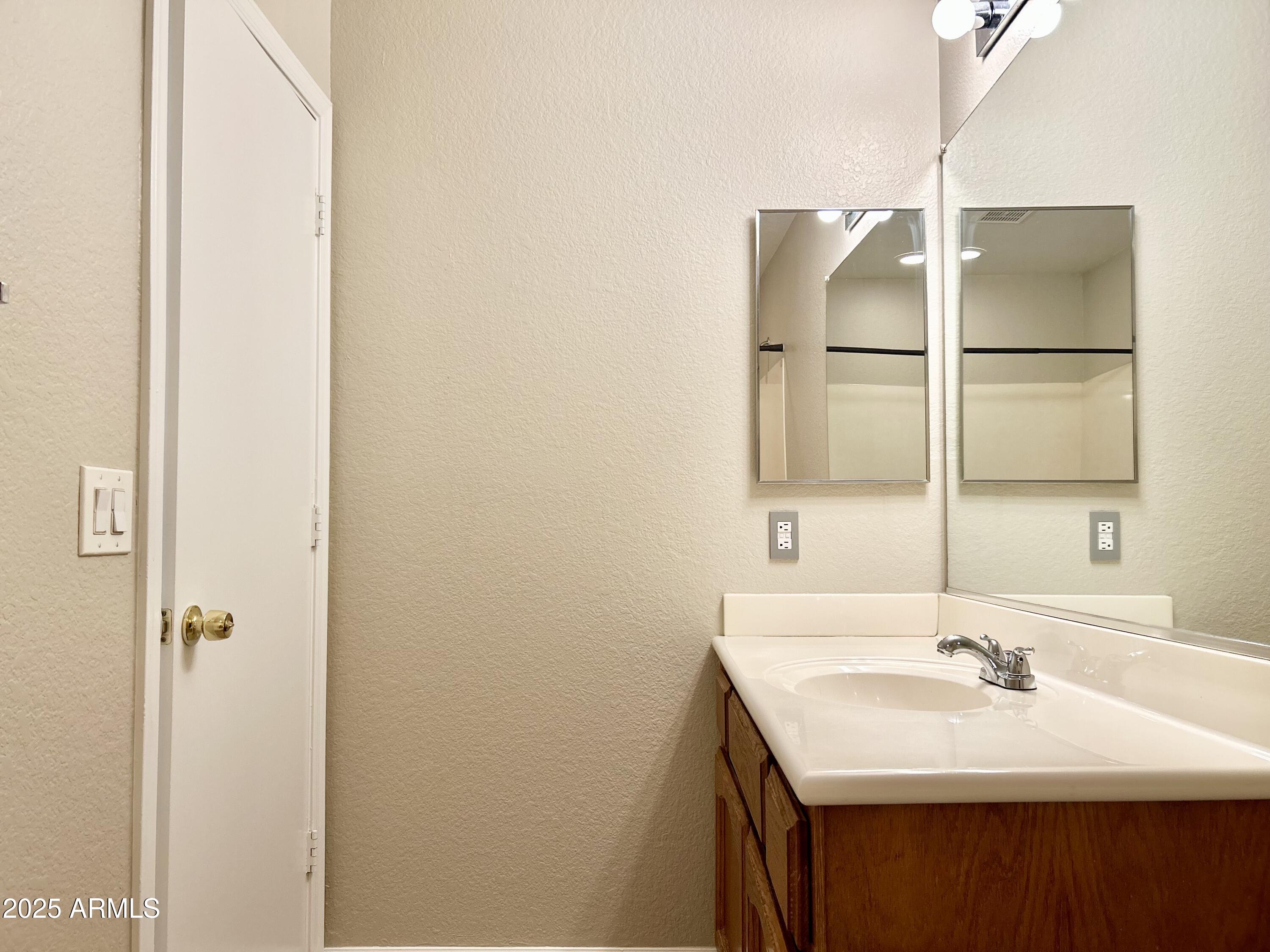 437 West San Angelo Gilbert, AZ 85233 - Photo 20 of 21 a bathroom with a sink and a mirror