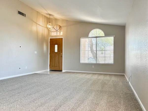 an empty room with windows and closet