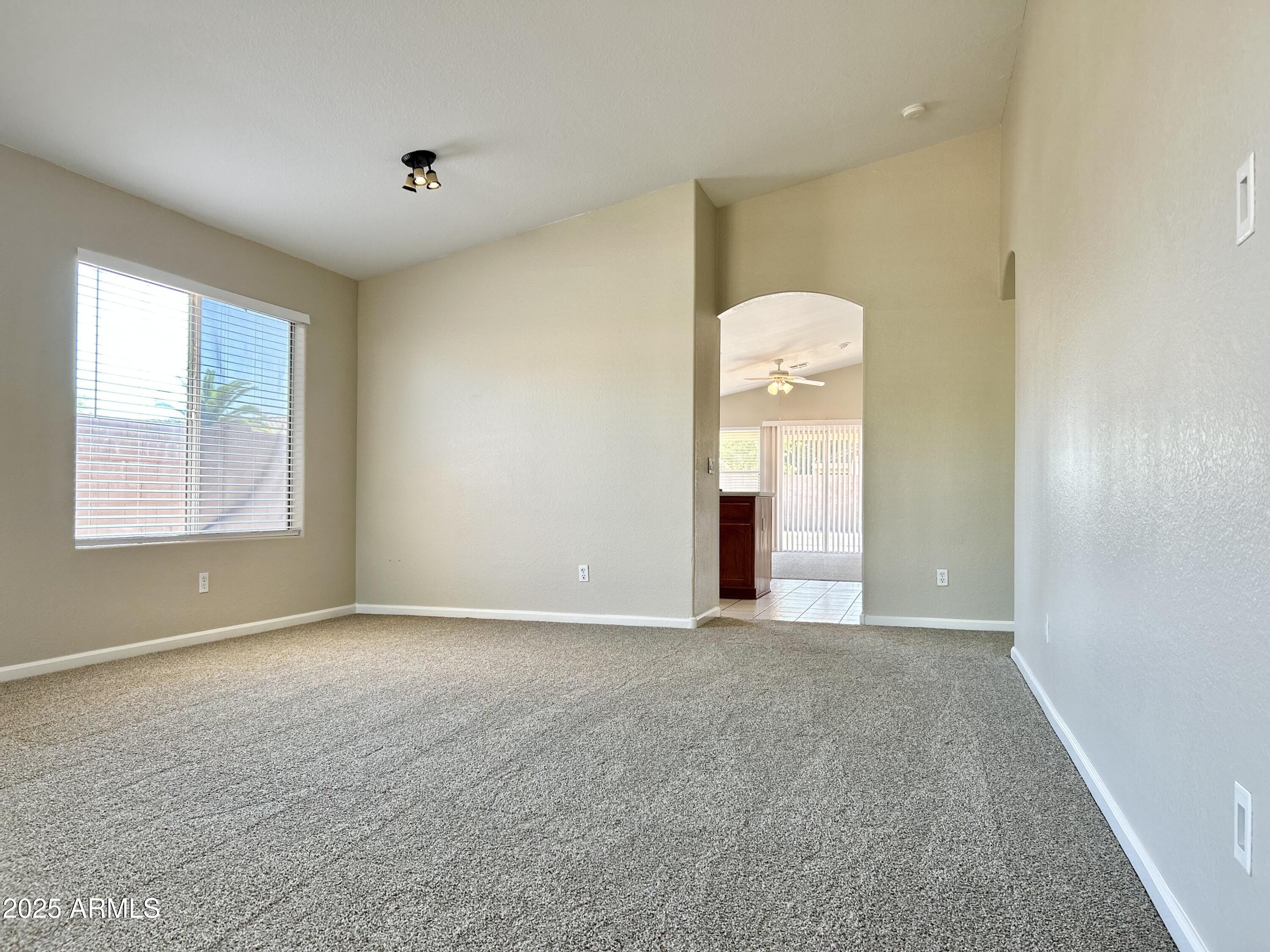 437 West San Angelo Gilbert, AZ 85233 - Photo 4 of 21 a view of an empty room with a window