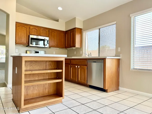 a kitchen with stainless steel appliances granite countertop a stove and a refrigerator