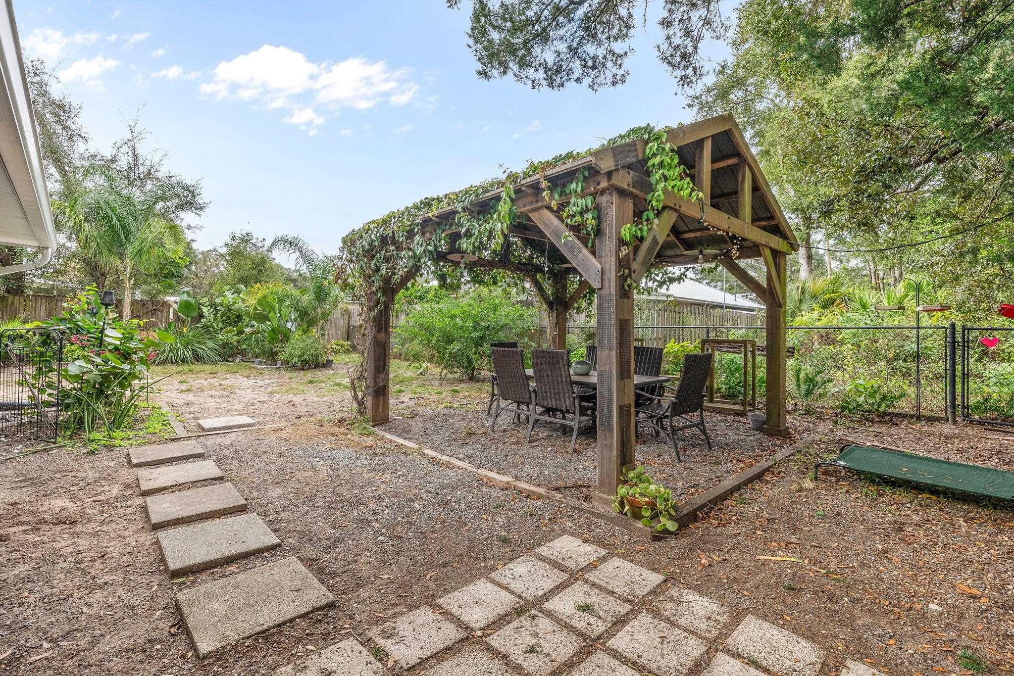 129 Pelican Road St. Augustine, FL 32086 - Photo 24 of 35 a view of a patio with table and chairs and potted plants