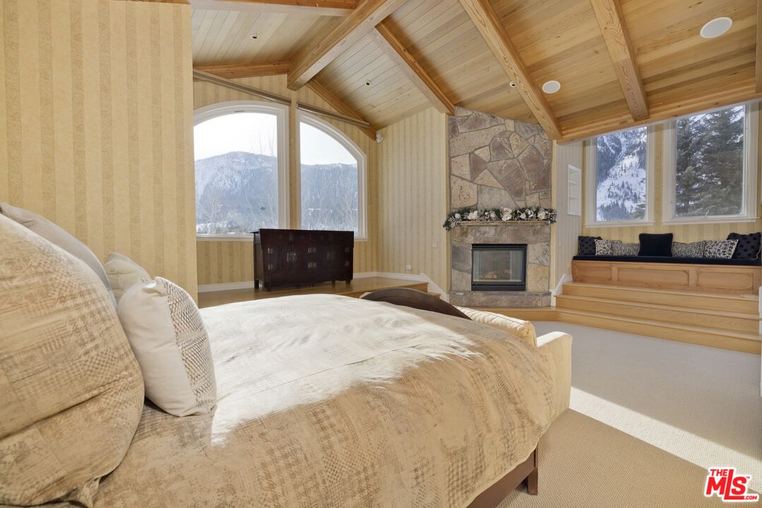 370 Ranch Road Mammoth Lakes, CA 93546 - Photo 24 of 38 a bedroom with a bed and a fireplace