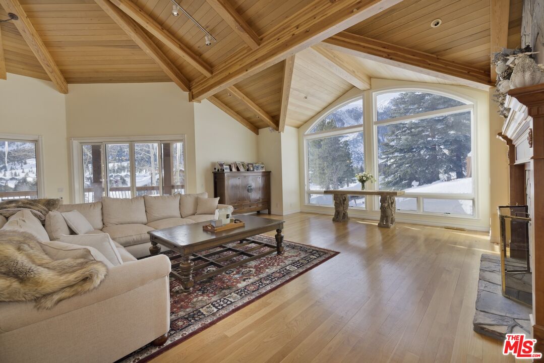 370 Ranch Road Mammoth Lakes, CA 93546 - Photo 3 of 38 a living room with fireplace furniture and a large window