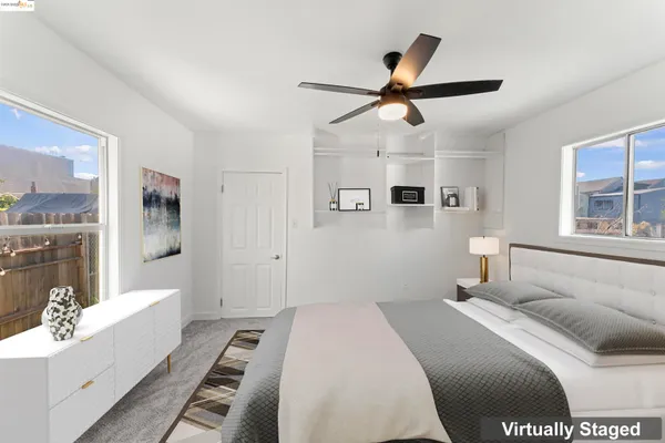 a bedroom with a large bed and a window