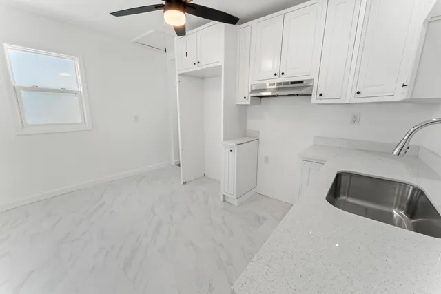 a view of a kitchen with stainless steel appliances cabinets
