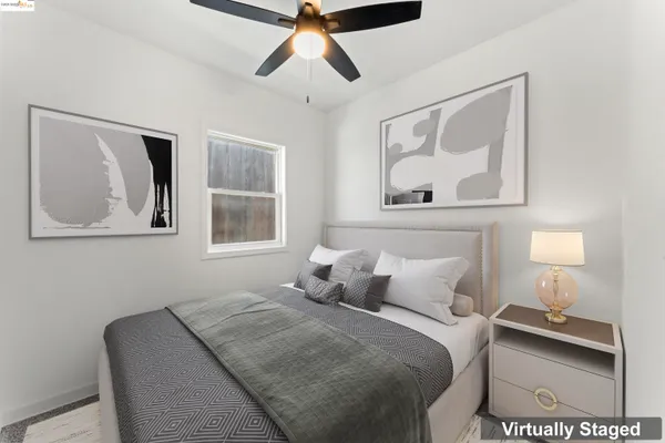 a bedroom with a bed and a painting on the wall