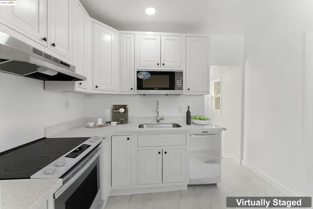 a kitchen with stainless steel appliances granite countertop a stove and a microwave