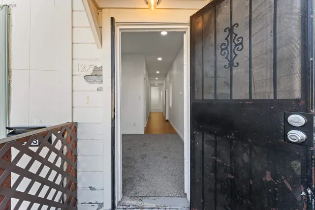 a view of a hallway with wooden floor