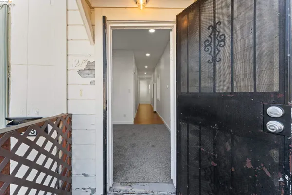 a view of a hallway with wooden floor