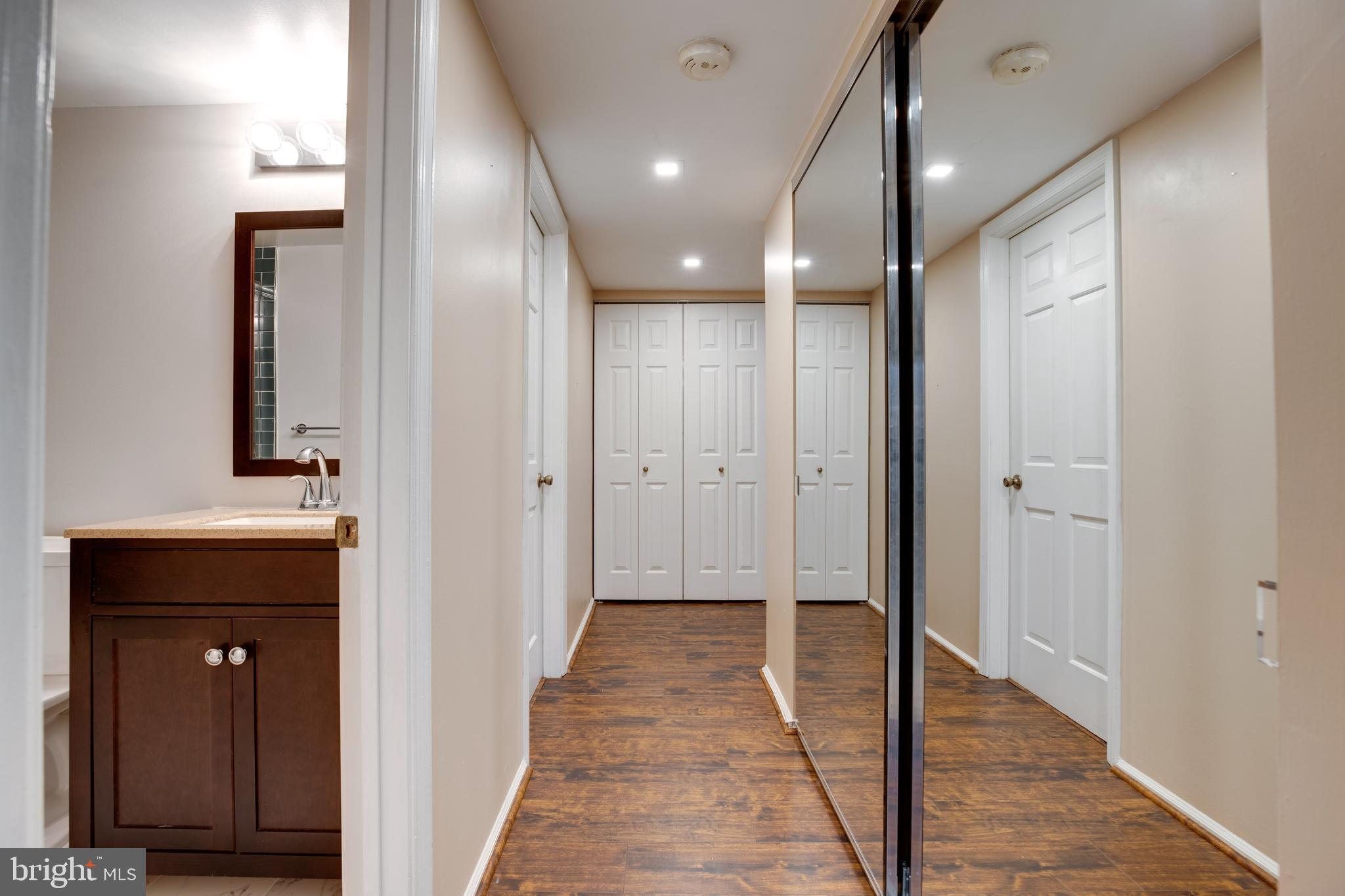 7651 Tremayne Place, Unit 202 McLean, VA 22102 - Photo 18 of 59 Hallway with Mirrored Closet Doors & 2nd Bath