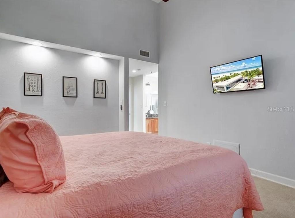 1926 Harbourside Drive, Unit 1302 Longboat Key, FL 34228 - Photo 12 of 31 a bedroom with a bed and a painting on the wall