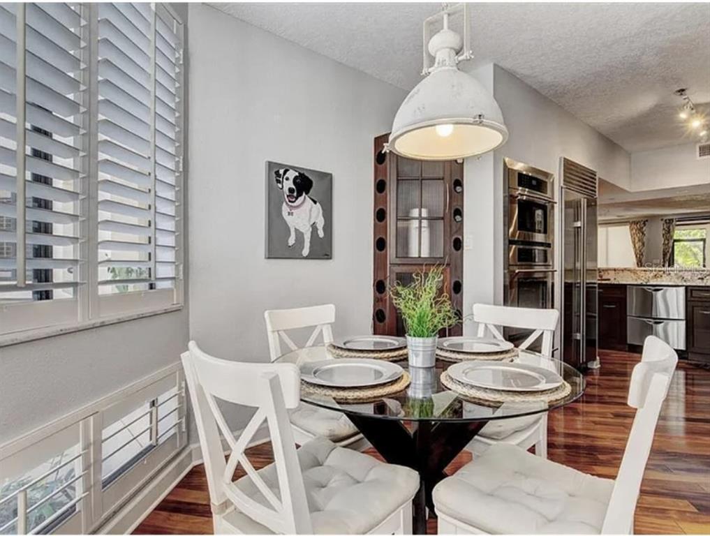 1926 Harbourside Drive, Unit 1302 Longboat Key, FL 34228 - Photo 15 of 31 a view of a dining room with furniture window and wooden floor