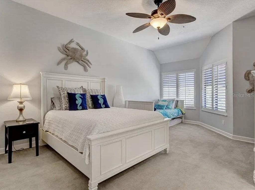 1926 Harbourside Drive, Unit 1302 Longboat Key, FL 34228 - Photo 16 of 31 a bed room with a bed and a chandelier