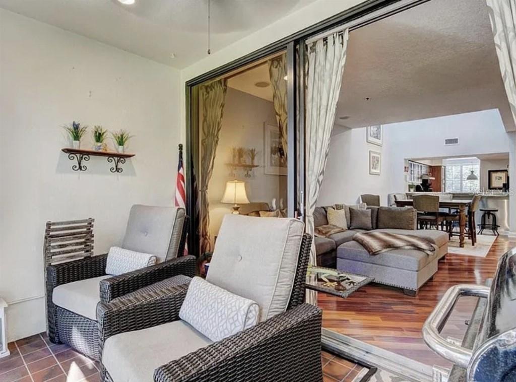 1926 Harbourside Drive, Unit 1302 Longboat Key, FL 34228 - Photo 23 of 31 a living room with furniture and wooden floor