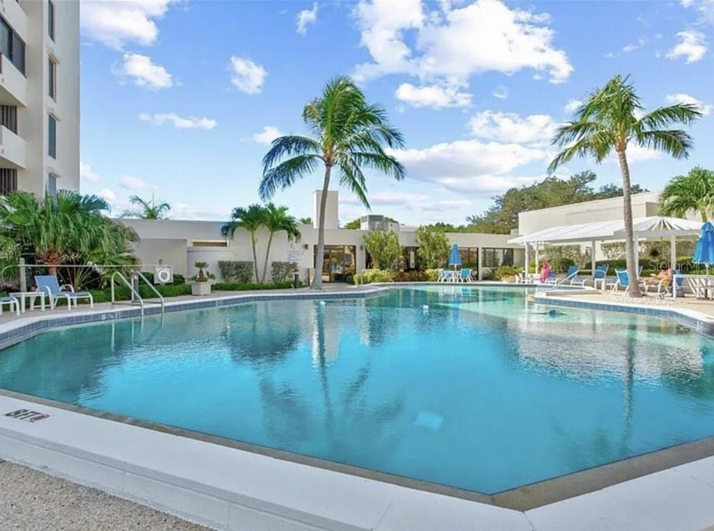 1926 Harbourside Drive, Unit 1302 Longboat Key, FL 34228 - Photo 27 of 31 a view of swimming pool with outdoor seating and lake view