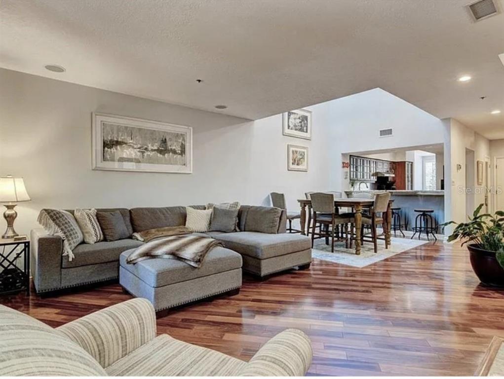 1926 Harbourside Drive, Unit 1302 Longboat Key, FL 34228 - Photo 3 of 31 a living room with furniture and wooden floor