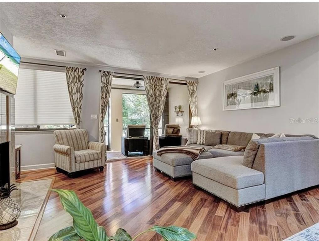 1926 Harbourside Drive, Unit 1302 Longboat Key, FL 34228 - Photo 5 of 31 a living room with furniture and a large window