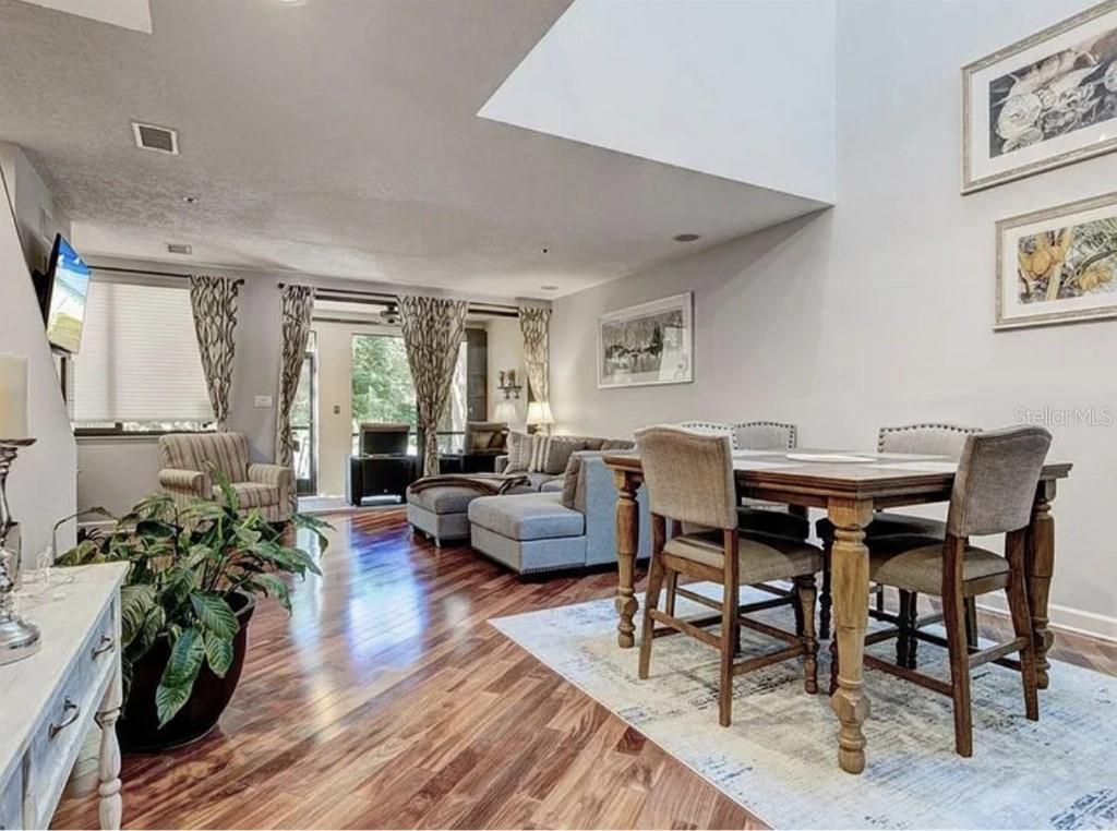 1926 Harbourside Drive, Unit 1302 Longboat Key, FL 34228 - Photo 6 of 31 a living room with furniture and a wooden floor