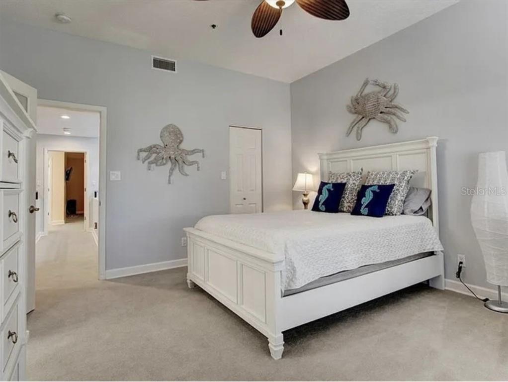 1926 Harbourside Drive, Unit 1302 Longboat Key, FL 34228 - Photo 8 of 31 a bedroom with a bed and cabinets