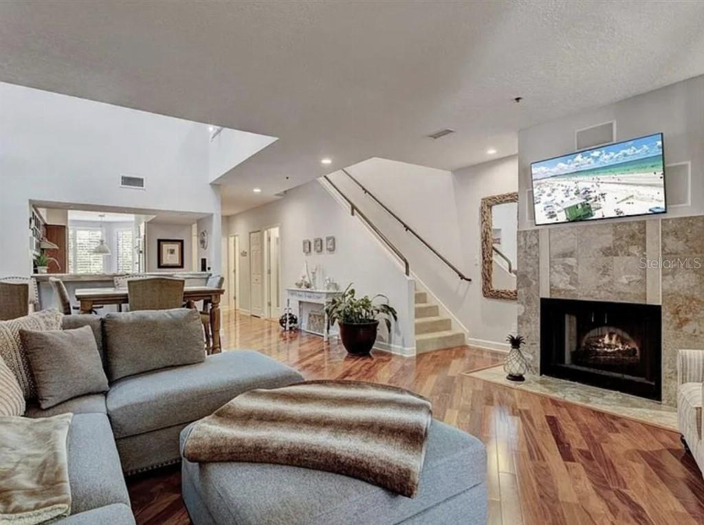 1926 Harbourside Drive, Unit 1302 Longboat Key, FL 34228 - Photo 9 of 31 a living room with furniture and a fireplace