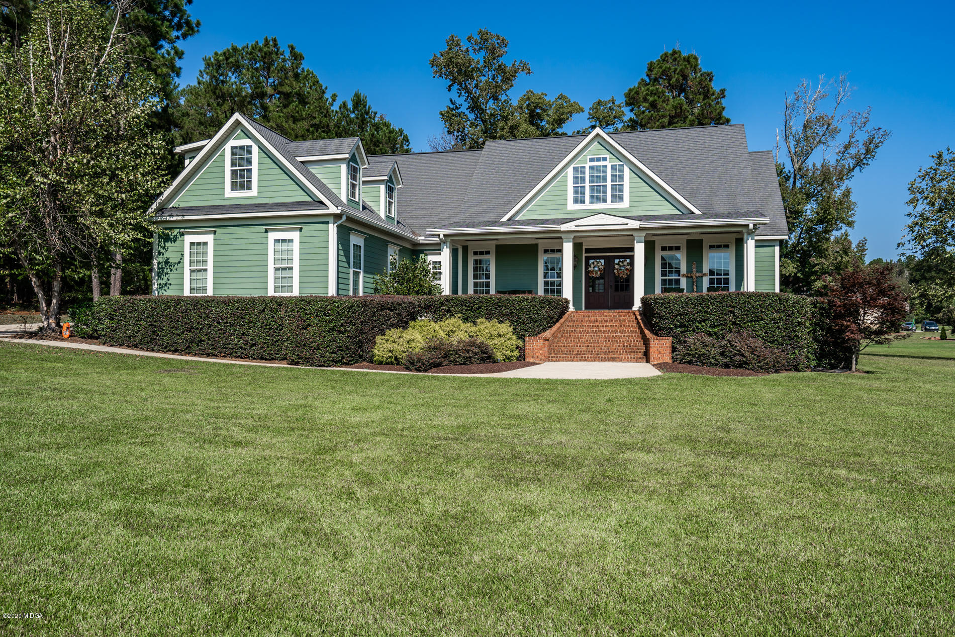 a front view of a house with a garden