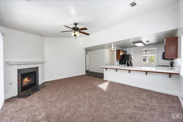a view of a kitchen with a sink and a fireplace