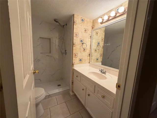 a bathroom with a shower and toilet