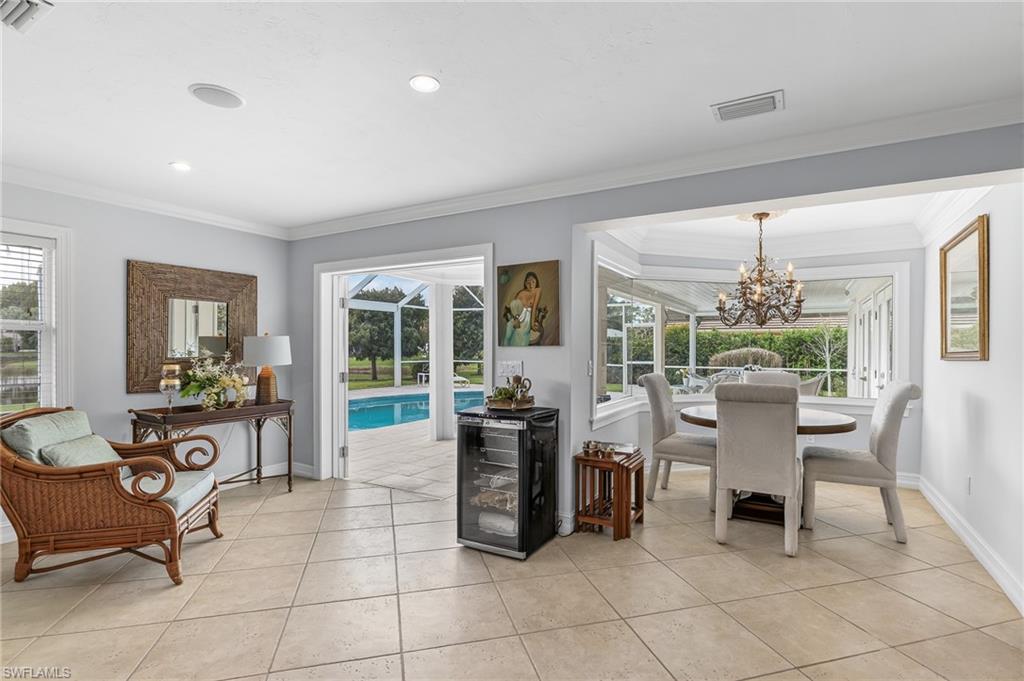 1904 Countess Court Naples, FL 34110 - Photo 10 of 33 a dining room with furniture and large windows