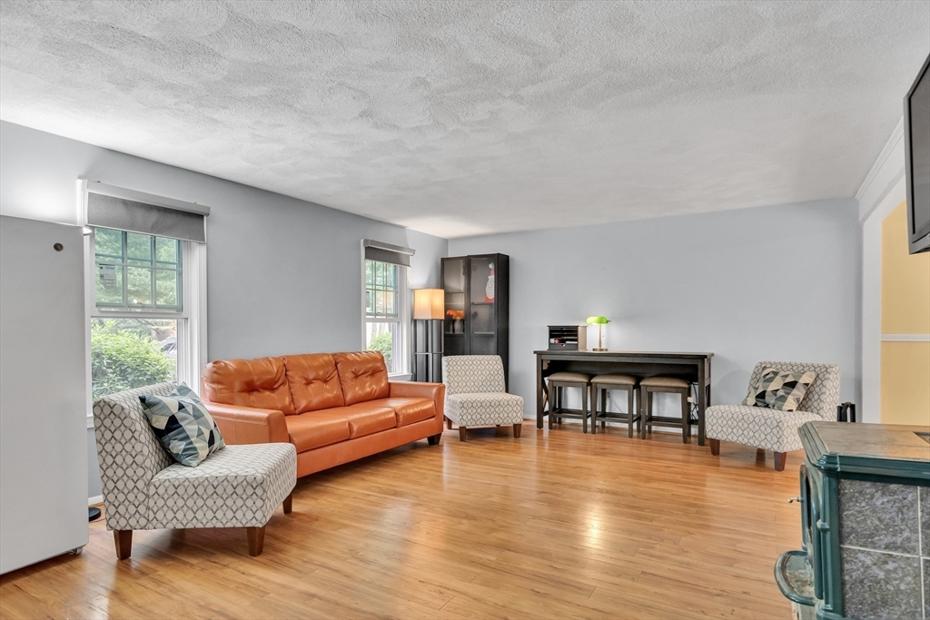 58 MacIntosh Lane, Unit 58 Boxborough, MA 01719 - Photo 10 of 23 a living room with furniture and a wooden floor