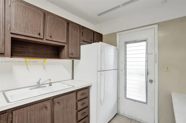 a white refrigerator freezer sitting inside of a kitchen