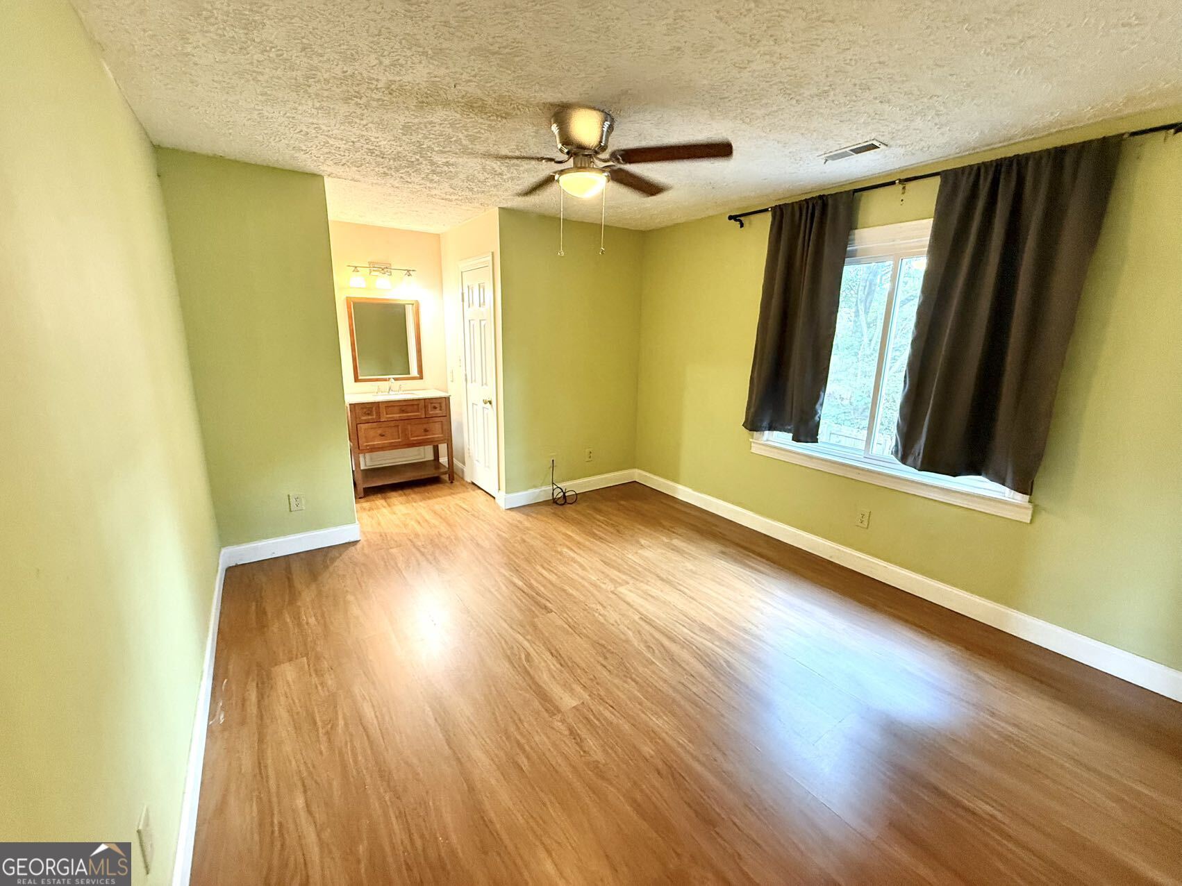 1220 Kennesaw Trace Court Kennesaw, GA 30144 - Photo 15 of 21 a view of empty room with wooden floor and fan