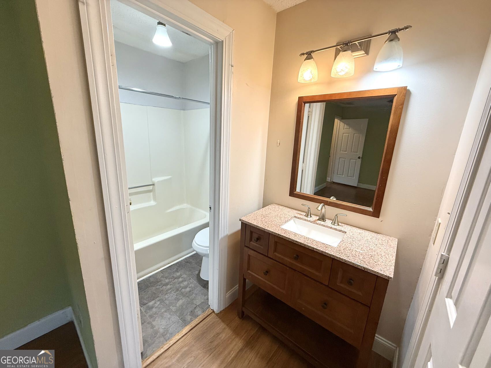 1220 Kennesaw Trace Court Kennesaw, GA 30144 - Photo 17 of 21 a bathroom with a sink a mirror and a bathtub
