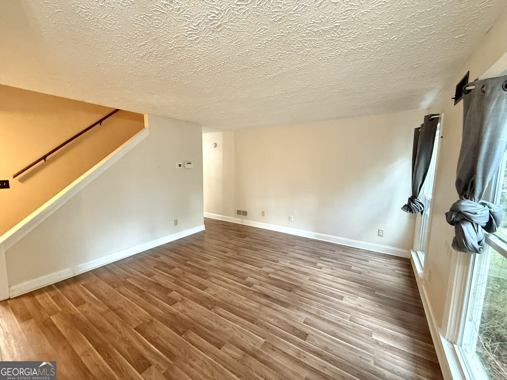 1220 Kennesaw Trace Court Kennesaw, GA 30144 - Photo 2 of 21 a view of a room with wooden floor and bench